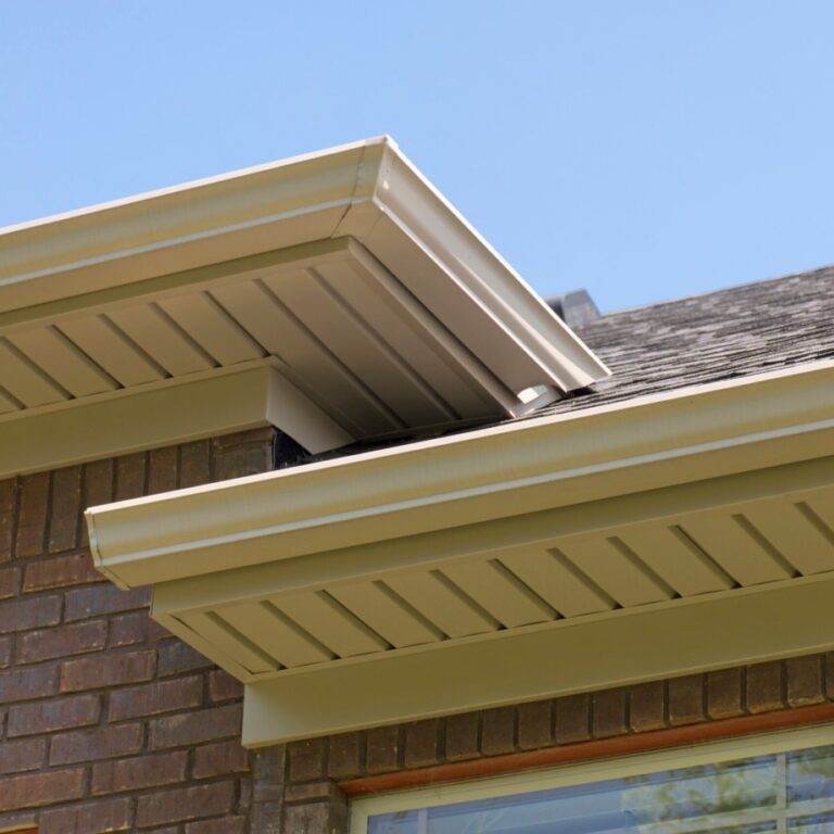 A ground level view of a completed gutter project on a residential home with two separate gutters