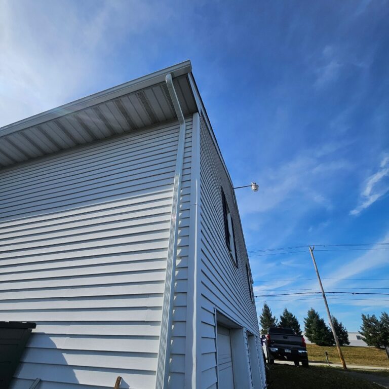 Side angle view of new gutters installed on a residential home and garage by The Exterior Company.