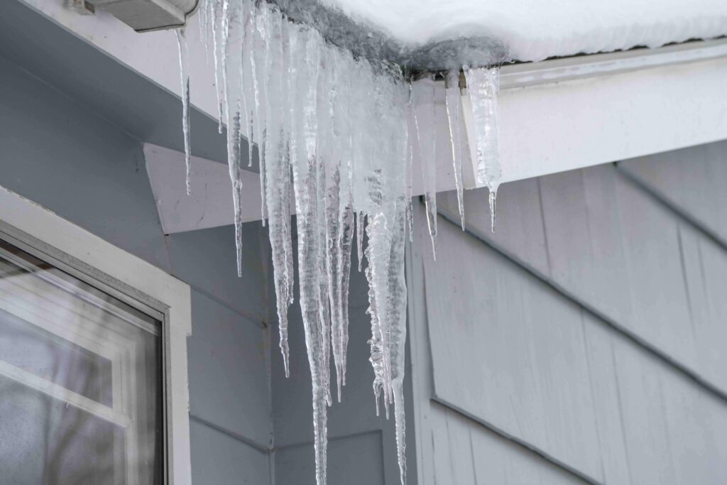 Ice overlapping a residential gutter