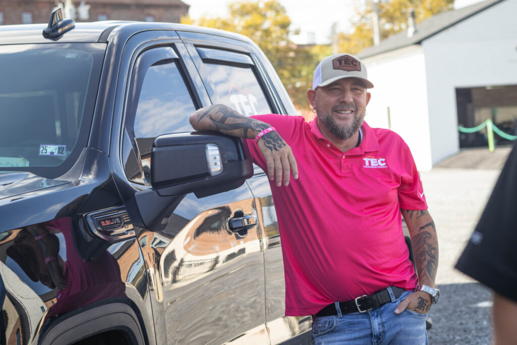 project manager outside sales posing by truck
