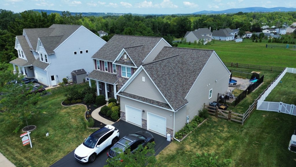 Aerial view of a residential home featuring professionally installed asphalt shingle roofing and quality exterior construction