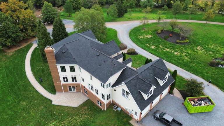 Aerial view of a residential property featuring a professionally installed asphalt shingle roof and completed exterior construction