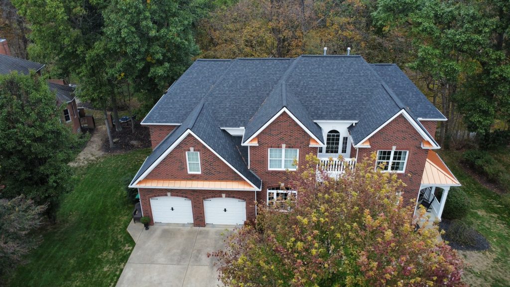 Aerial view of a residential home featuring professionally installed asphalt shingle roofing and quality exterior construction