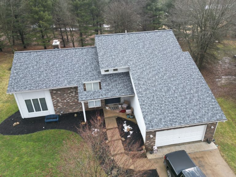Aerial view of a residential home featuring professionally installed asphalt shingle roofing and quality exterior construction