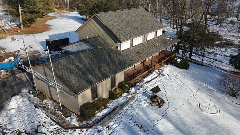 Aerial view of a residential property featuring professionally installed asphalt shingle roofing and quality exterior construction