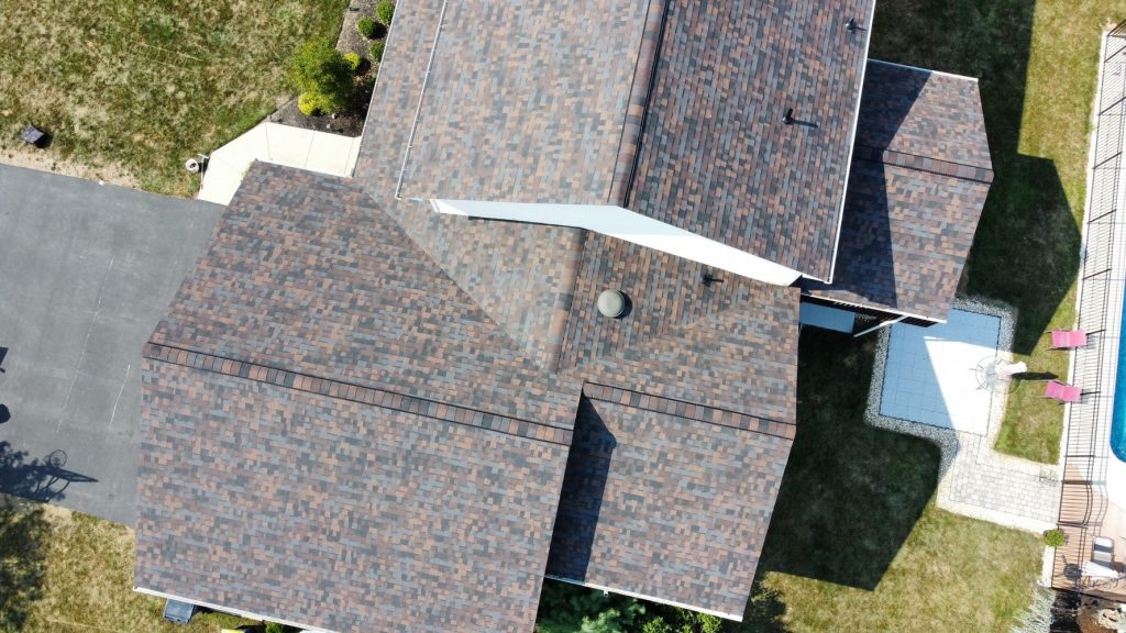 Aerial view of a residential property with a newly installed asphalt shingle roof