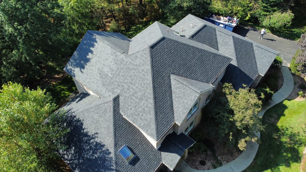 Aerial view of a residential property featuring professionally installed asphalt shingle roofing and quality exterior construction