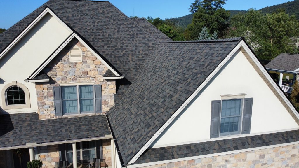 A residential home featuring professionally installed asphalt shingle roofing and exterior construction