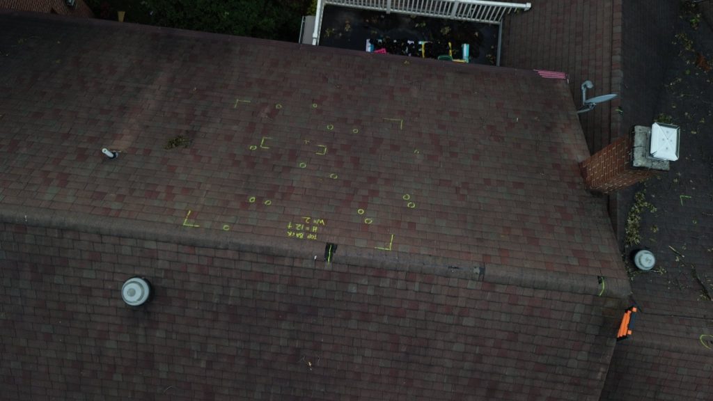 Storm damaged roof with inspection markings in Leola, PA