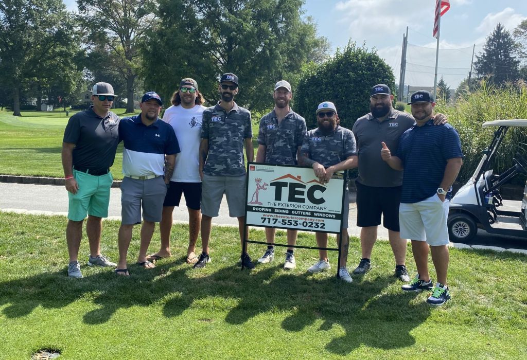 group of TEC roofers, project managers standing together for golf sponsorship